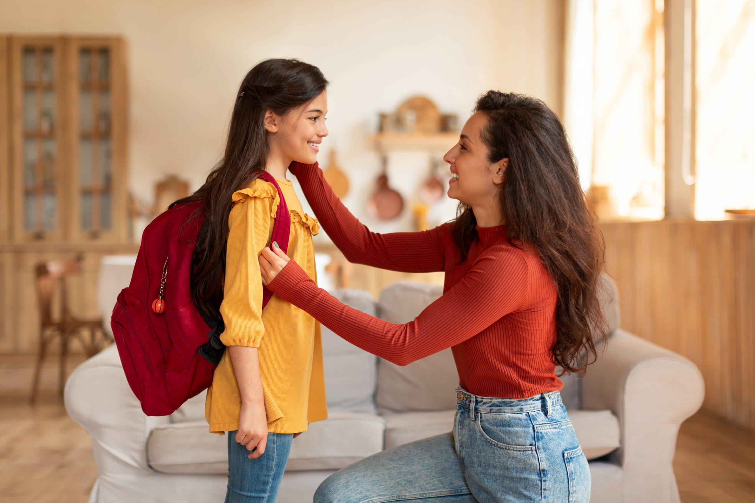 Mother getting her child ready for back to school